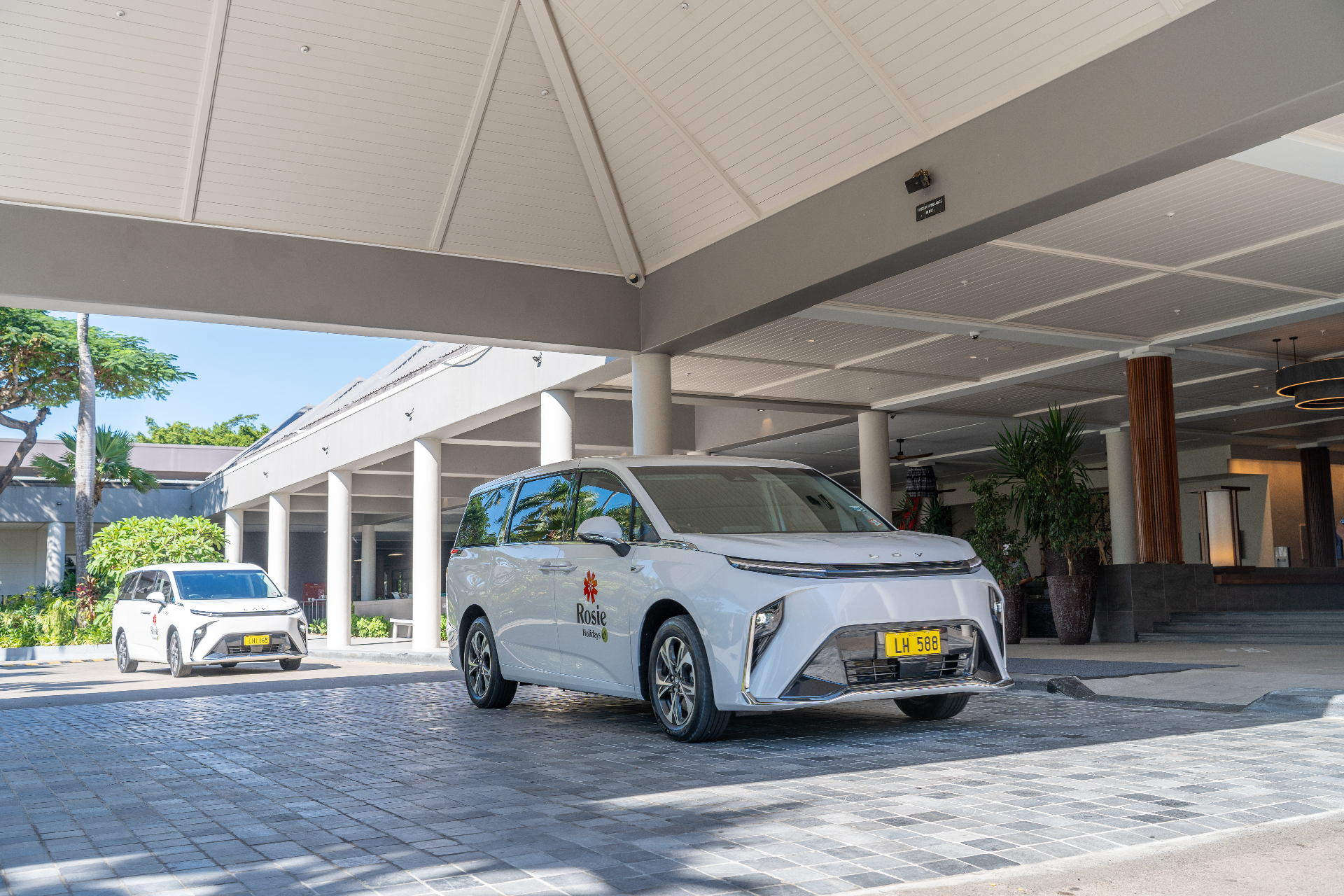 White electric van at Holiday Inn Hotel Suva resort entrance
