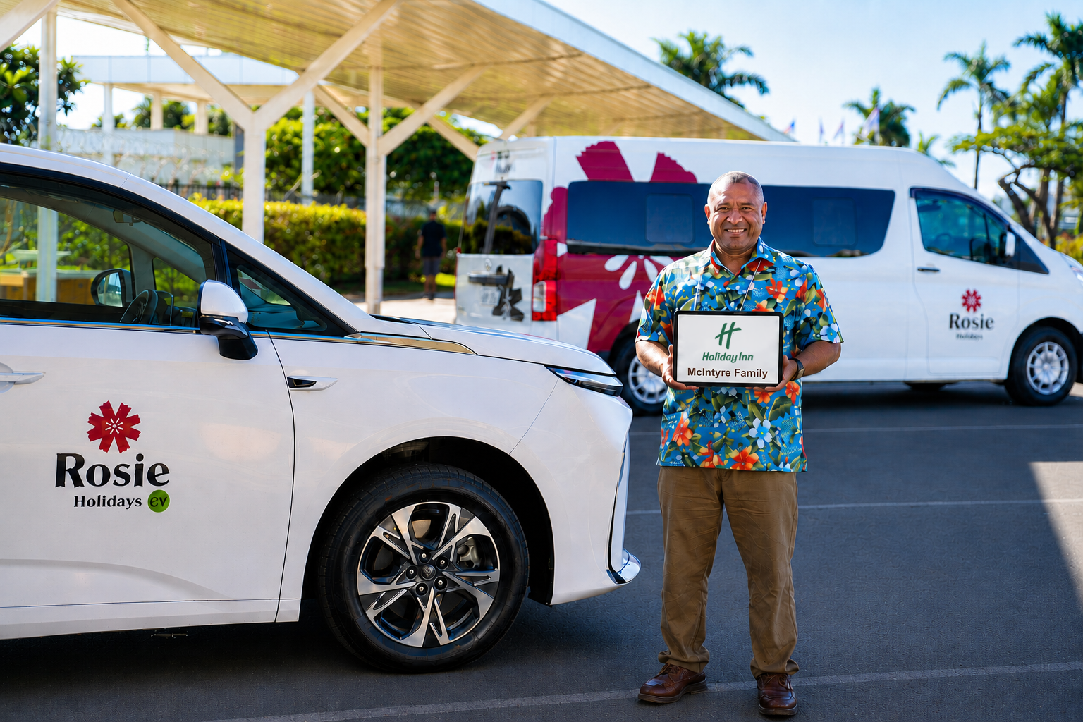 Rosie Holidays driver with Holiday Inn Hotel Suva welcome sign beside EV fleet